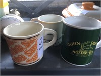 Sambo’s coffee mug, John Deere coffee mug, and