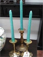 3 brass candle stick holders with 3 blue candle