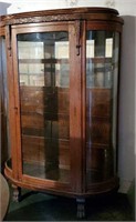 Antique oak china cabinet with curved glass,