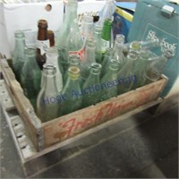Glass pop bottles with wooden pop crate