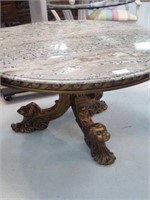 Table with engraved faces on the legs