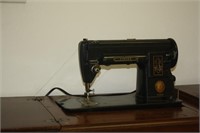 Singer Model 301 sewing machine in cabinet with ch