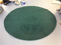 Round green woven rug