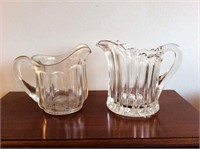 2 clear glass pitchers, 9 inches tall.