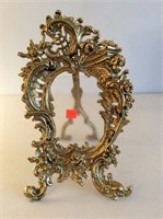 Brass frame with cherubs, 13” tall.