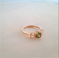 Size 8 925 ring. Gold coloured with green and