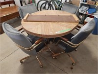 Wood Table With Four Wheeled Fabric Chairs