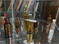 Eight miniature medicine bottles in clear & amber