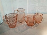 4 pink depression glass pitchers all different