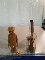 Hand carved man and bottle of tools