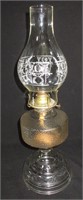 An Oil Lamp With Stencil Decorated Chimney