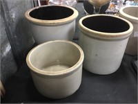 Three pottery crocks.