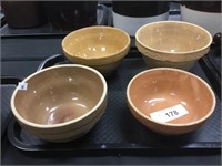 Four small pottery mixing bowls.