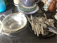 Flatware, chafing dish, pottery teapot, plates.