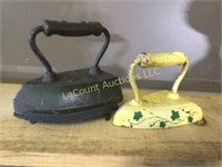 2 heavy cast iron clothes irons painted 1 base