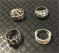 Four sterling silver rings.