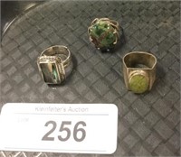 Three sterling silver rings.