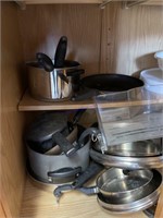 Cabinet with cooking pots and pans with lids