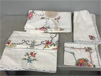 box of various embroidered linens