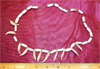 SHELL BEADS AND WOLF'S TEETH