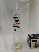 Glass tower thermometer with colored floats -