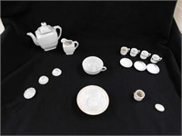Child's white antique china tea set pieces.