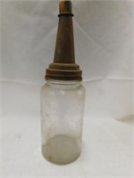 Glass oil bottle with metal spout and cap.