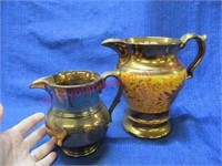 (2) antique luster pitchers (7in & 5in tall)