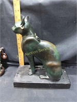 Bronze cat statue on marble base