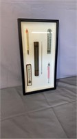 6 old thermometers in a showcase frame.  
25 in.