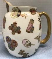 CREAM AND GOLD ORIENTAL PITCHER