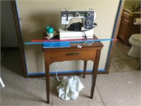 2 sewing machines and a cabinet