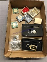 tray of John Deere items- belt buckle, pen sets, s
