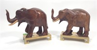 Two mahogany carved wood elephants on brass