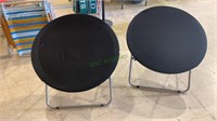 Two black round folding chairs, snap in place,