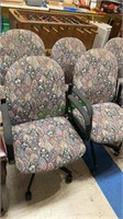 Four matching floral upholstered office chairs,
