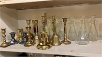 Group of brass table bells, candle sticks, and