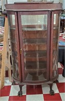 Antique oak paw foot bow front china cabinet