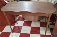 Antique solid walnut table w scalloped edge.