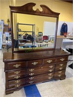 Cherry eight drawer dresser with a large mirror,