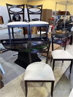 Modern black pedestal table with four chairs, has