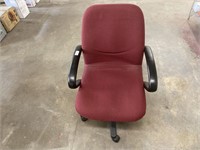Maroon office chair on rollers