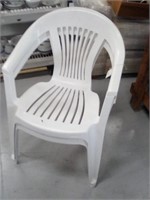 2 stacking white plastic chairs