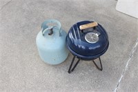 Small Charcoal Grill and Empty Propane Tank