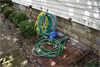 3 garden hoses and watering can