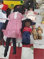 3 black rag cloth dolls and 2 caribbean type dolls