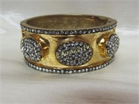 Gold Tone hinged bracelet with white stones