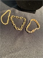 Three gold colored bracelets all marked 925