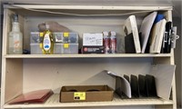 Contents of shelving unit with office supplies