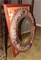 Oval decorated mirror and  wooden decorated wall